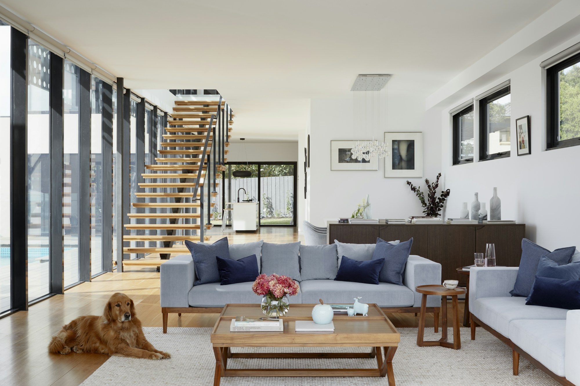 Light-filled living room and timber staircase; stock design reference